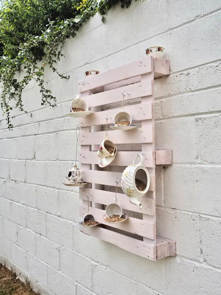  A teacup is the perfect size for a bird feeder, and they're super cute to look at
