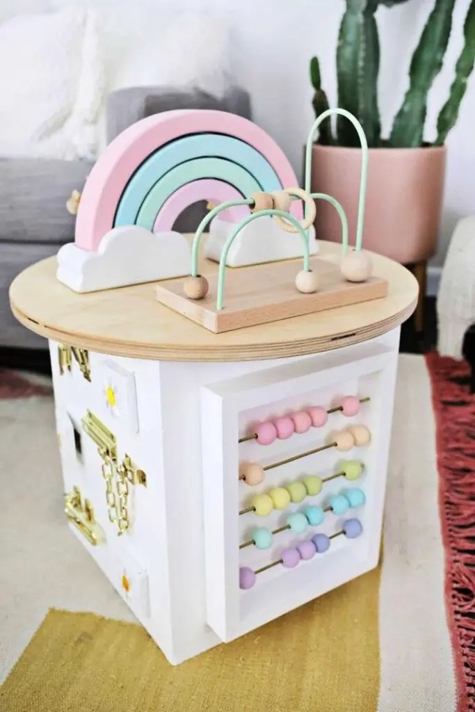 Wooden toddler activity center with colorful interactive elements